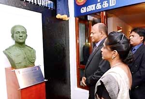 Bronze statue and memorial plaque honoring Colonel Fazly Laphir of the Sri Lanka Army Special Forces, displayed with floral tributes during a remembrance event.