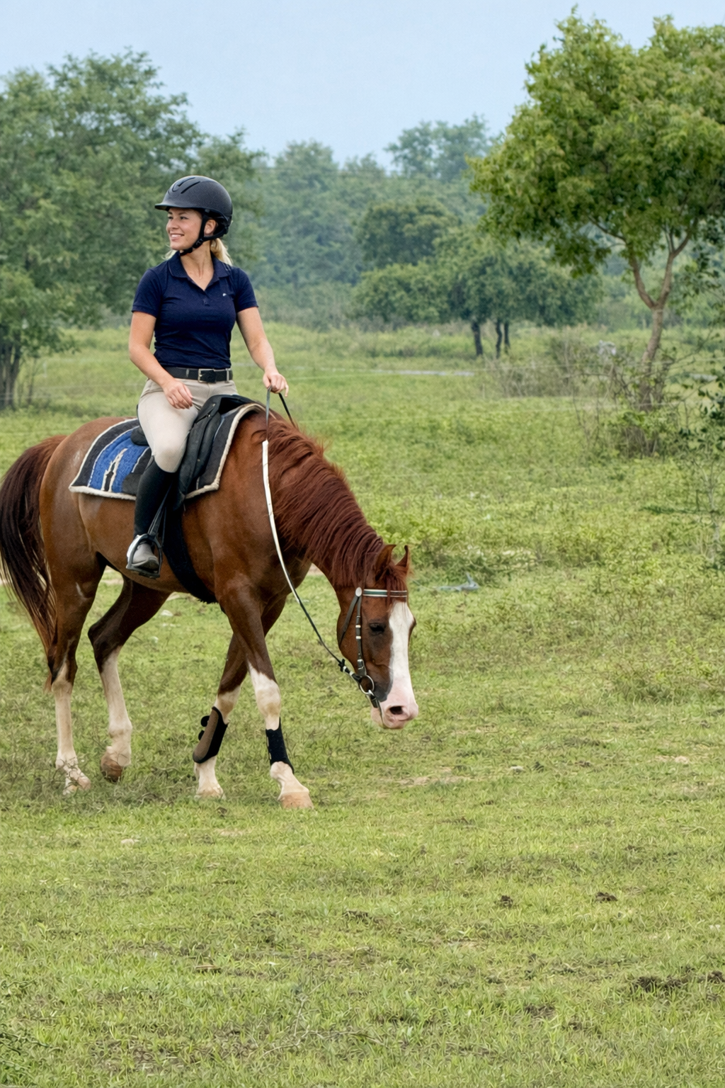 Helmeted rider on a relaxed chestnut horse during a riding holiday at Vonfidel Ranch in Sri Lanka, demonstrating calm, trust-based horsemanship.