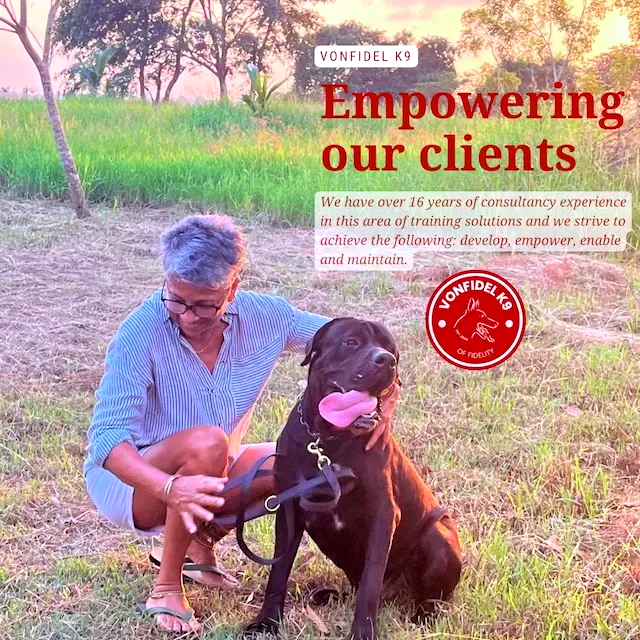 A high-end client gently petting her calm and confident dog during a reunion at VONFIDEL K9 inside Vonfidel Ranch, showing trust-based transformation in a peaceful natural environment.